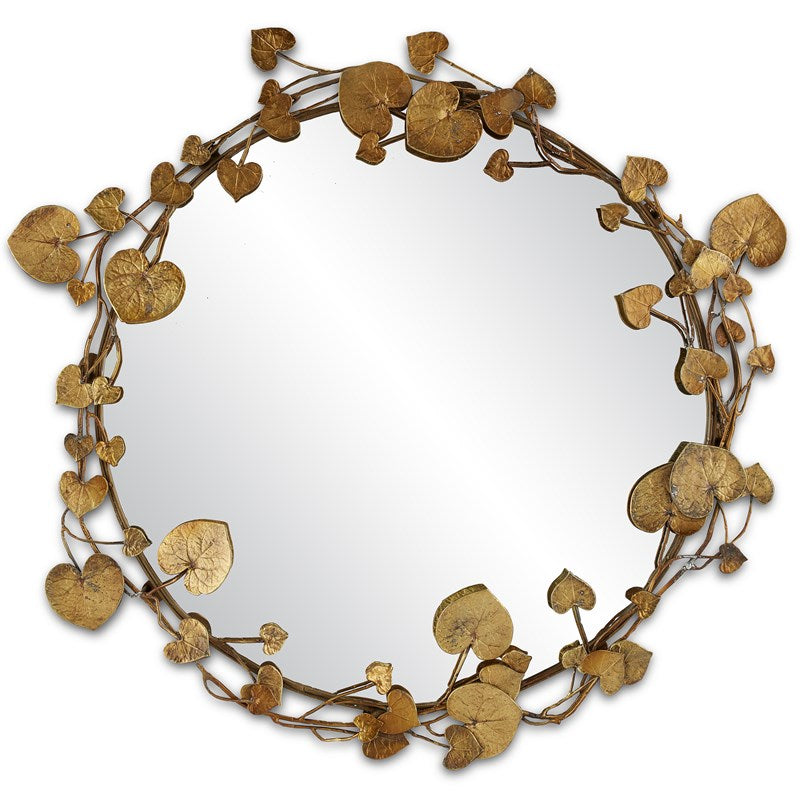 An image of the Vinna Brass Round Mirror by Currey & Company with an antique brass finish, 32 inches in diameter, surrounded by beautiful leaves inspired by nature.